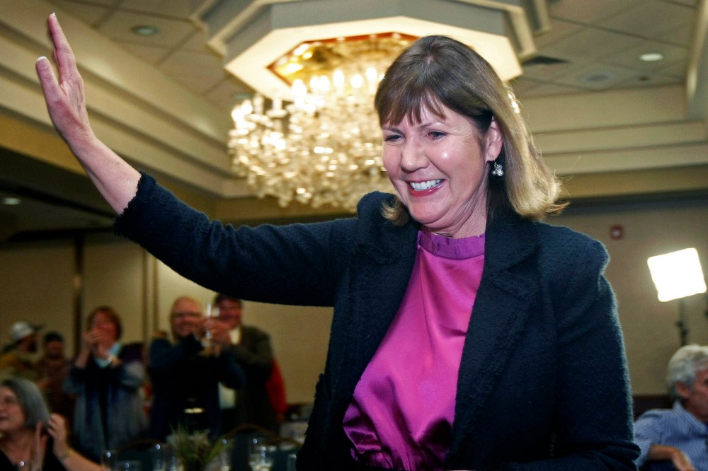 Ann Kirkpatrick waves as she enters a room full of supporters during an election night in Flagstaff, Ariz., Nov. 6, 2012.