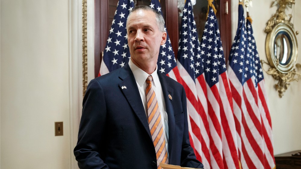 Rep. Curt Clawson, R-Fla., carries a Bible for as ceremonial swearing-in with Speaker of the House John Boehner, R-Ohio, at the Capitol in Washington, Wednesday, June 25, 2014.