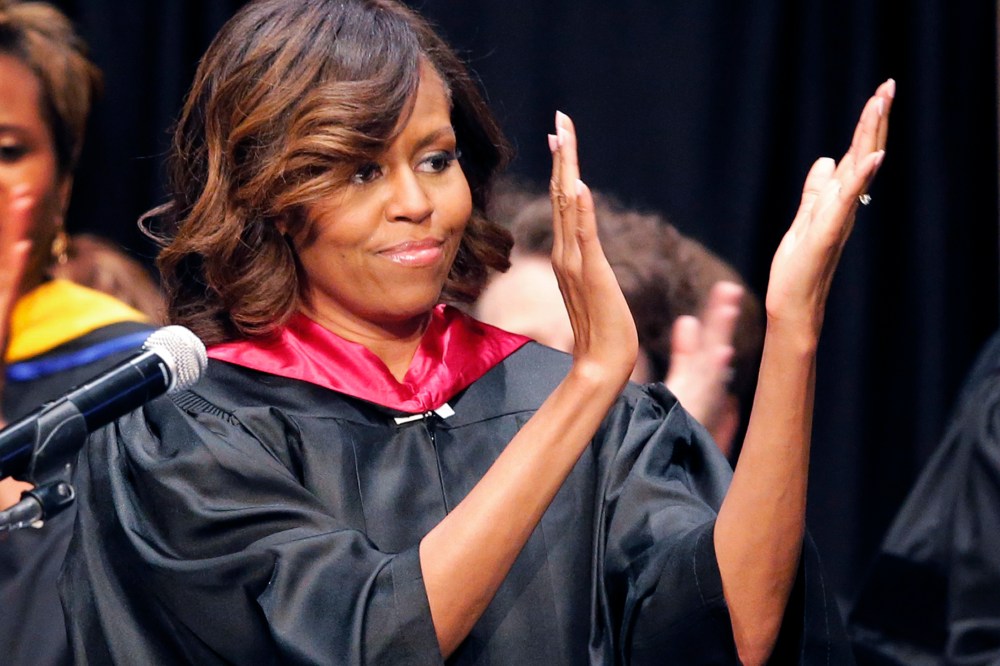 First lady Michelle Obama applauds students during Topeka Public Schools Senior Recognition Program in Topeka, Kan., May 16, 2014.