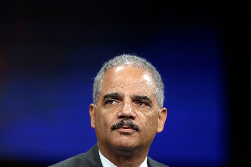 Attorney General Eric Holder listens to a speech ahead of his remarks during the Annual International Association of Chiefs of Police Conference on Oct. 21, 2013