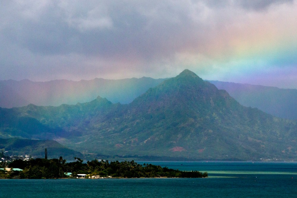 President Barack Obama's motorcade passes Kaneohe Bay as heads for the beach at Bellows Air Force Station, Jan. 3, 2015, on the island of Oahu in Hawaii, on the final day of the Obama family vacation. (Photo by Jacquelyn Martin/AP)