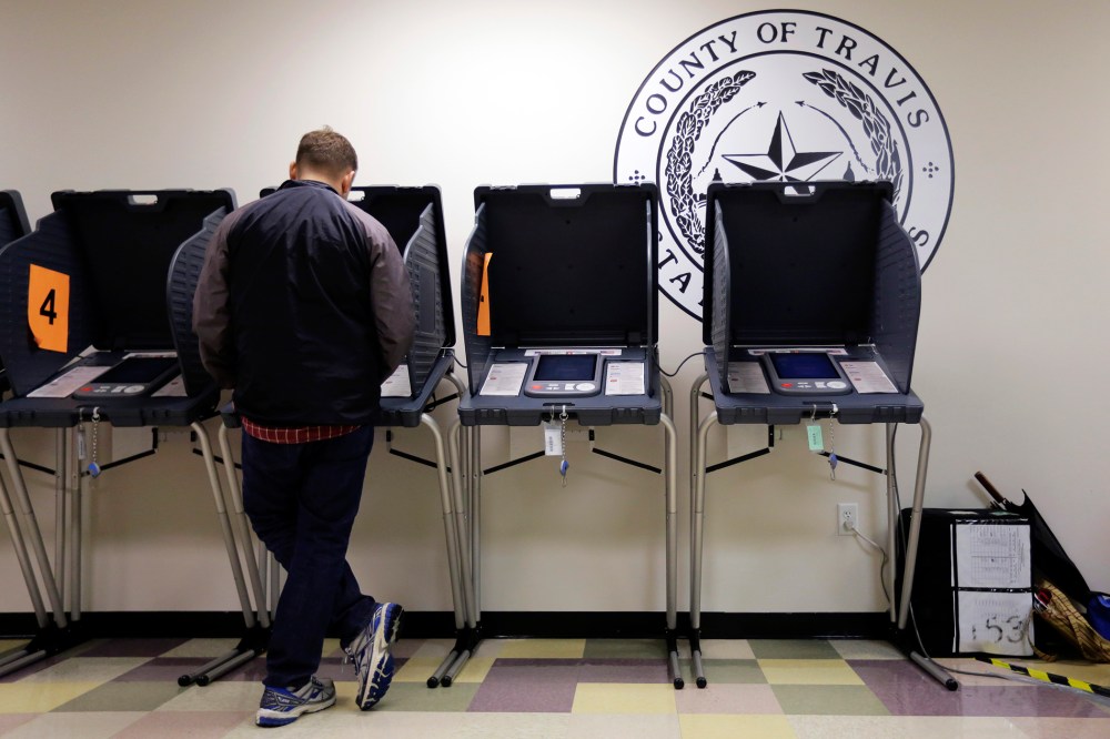 In this Wednesday, Feb. 26, 2014 photo, a voter casts his ballot at an early voting polling site, in Austin, Texas.