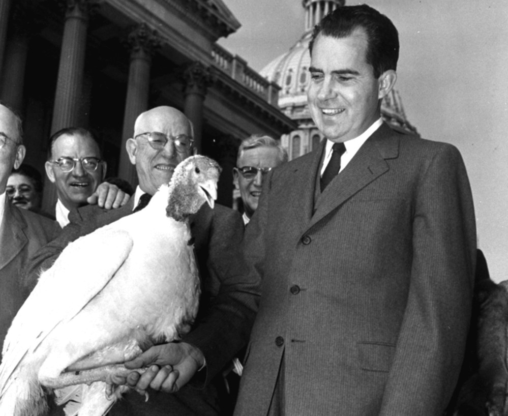 Vice President Richard Nixon "shakes hands" with a 40-pound white turkey on November 14, 1955, at the Capitol in Washington, D.C. The big bird was not pardoned, but was destined for President Eisenhower's Thanksgiving dinner. (AP Photo/William J. Smith)