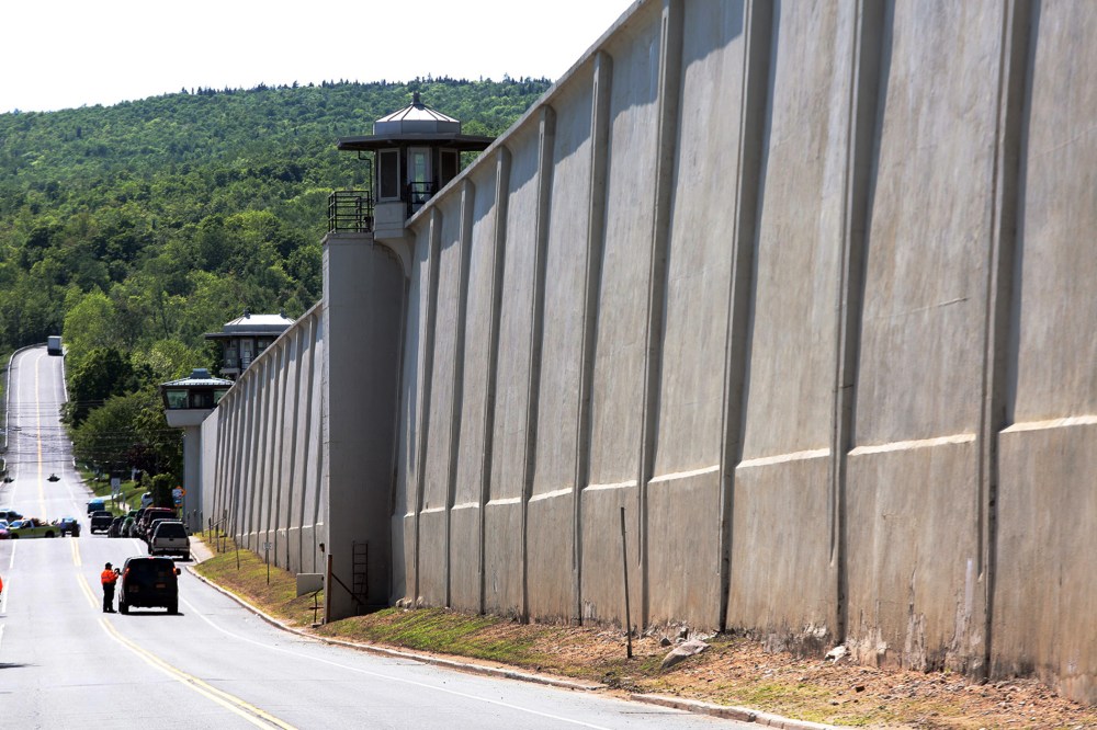 Law enforcement officers stand guard near one of the walls of the Clinton Correctional Facility in Dannemora, N.Y. on June 6, 2015. (Photo by Gabe Dickens/Press Republican/AP)