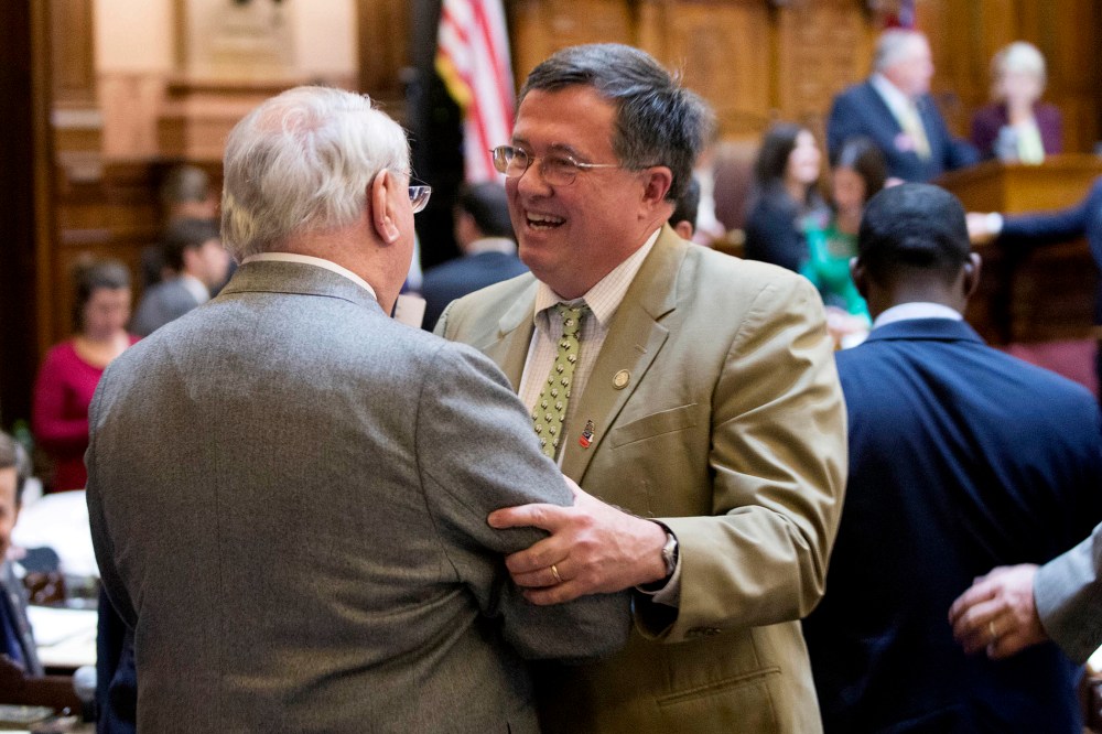 Georgia Rep. Rick Jasperse, R-Jasper, facing, celebrates with Rep. Wendell Willard, R-Sandy Springs, after a gun bill passed in the House Chambers on the last day of the legislative session at the Georgia State Capitol, on March 20, 2014, in Atlanta.