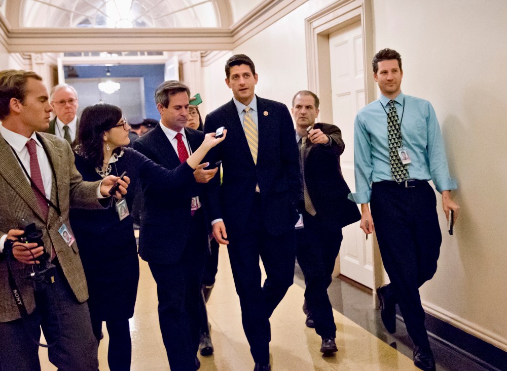 House Budget Committee Chairman Rep. Paul Ryan, R-Wis., center, is pursued by reporters on Capitol Hill in Washington on Thursday, Oct. 10, 2013