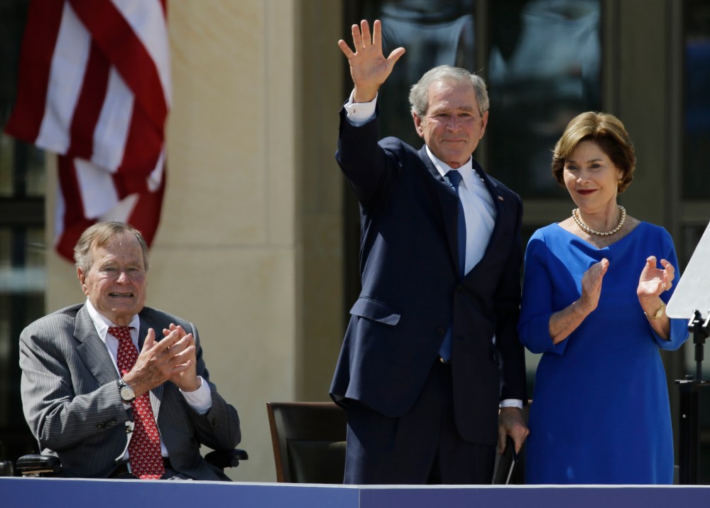 Former president George H.W. Bush, left, applauds with Laura Bush after former president George W. Bush's speech during the dedication of the George W. Bush Presidential Center Thursday, April 25, 2013, in Dallas. (AP Photo/David J. Phillip)