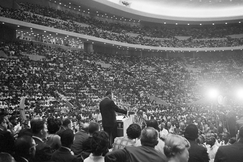 Rev. Martin Luther King Jr., speaks to an overflow crowd in Detroit's Cobo Hall Arena on Sunday, June 24, 1963, following a Freedom March.  (AP Photo)
