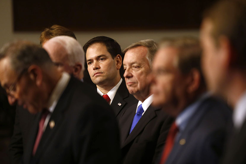 Sen. Marco Rubio, R-Fla., center, and others Senators, participate in a news conference on immigration,  April 18, 2013, on Capitol Hill in Washington. (Photo by Charles Dharapak/AP)