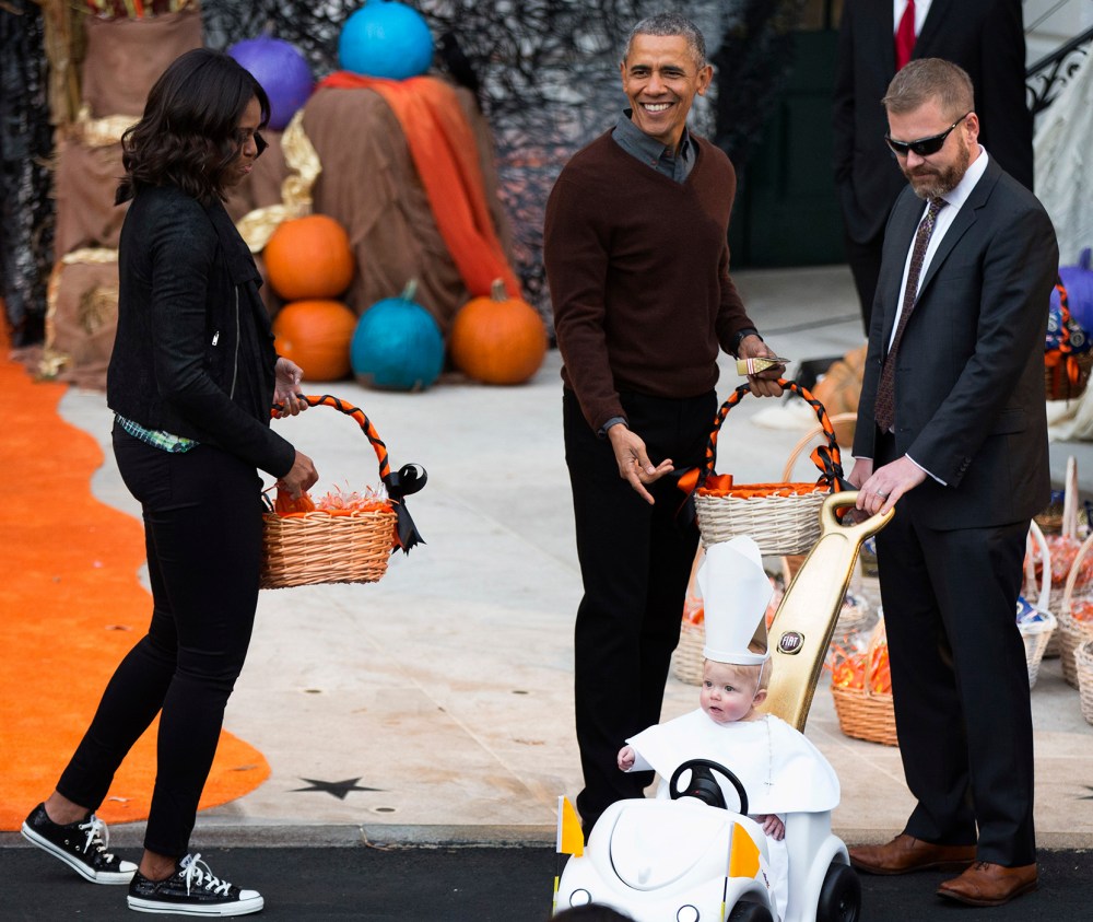 President Barack Obama and first lady Michelle Obama greet a child dressed as the pope during Halloween festivities at the South Portico of the White House in Washington, Oct. 30, 2015. (Photo by Andrew Harnik/AP)