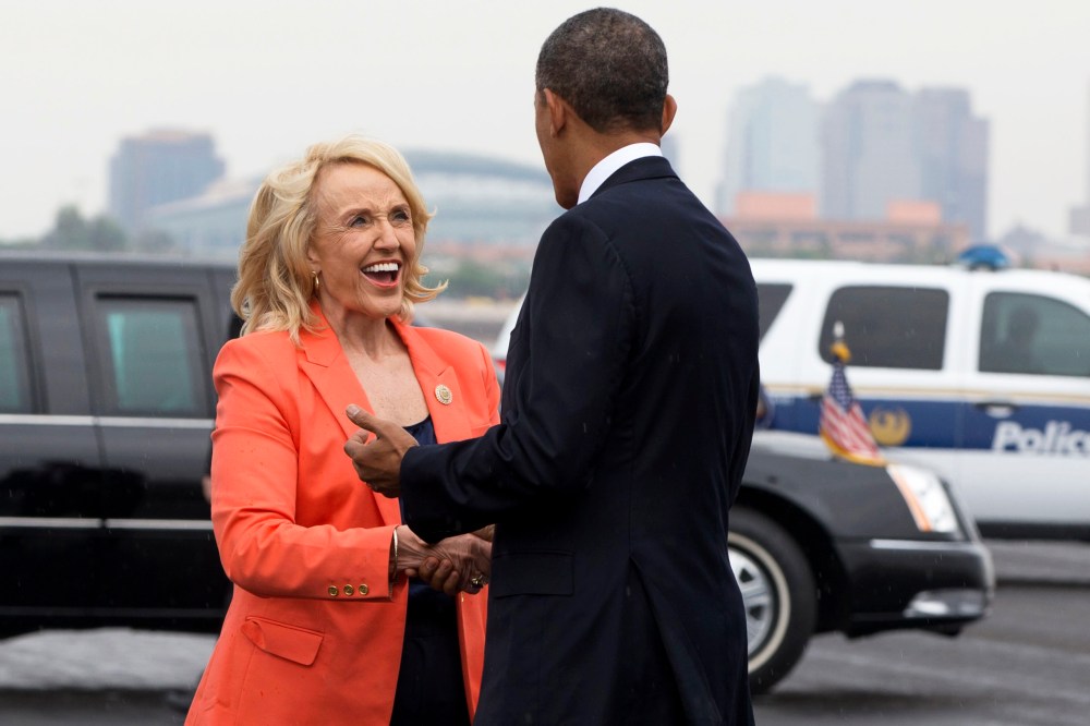 Arizona Gov. Jan Brewer greets President Barack Obama on his arrival in Phoenix, Tuesday, Aug. 6, 2013.