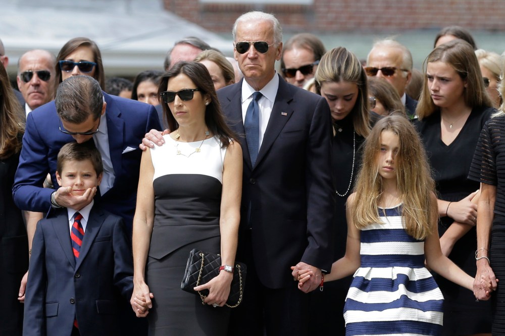 Hunter Biden, left, kisses his nephew Hunter, son of Beau Biden, as they stand with Beau's widow Hallie, Vice President Joe Biden, and Beau's daughter Natalie before his funeral, on June 6, 2015, in Wilmongton, Del. (Photo by Patrick Semansky/AP)