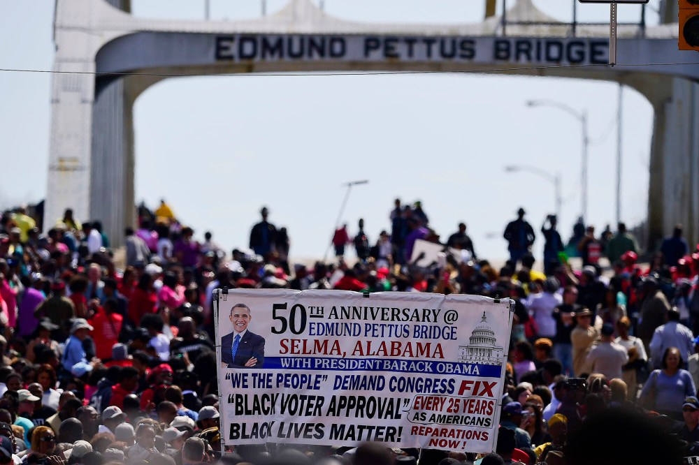 Crowds take a symbolic walk across the Edmund Pettus Bridge on March 8, 2015, in Selma, Ala. (Photo by Bill Frakes/AP)