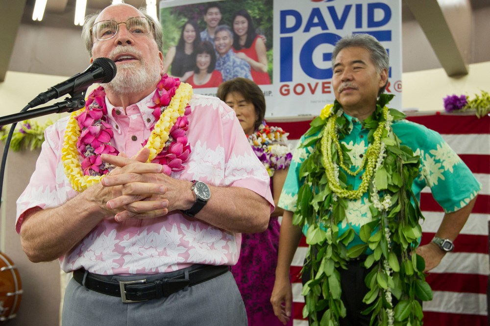 Hawaii Governor Neil Abercrombie, left, addresses the supporters of Hawaii State Sen. David Ige as Ige, right, looks, Aug. 9, 2014, in Honolulu, Hawaii.
