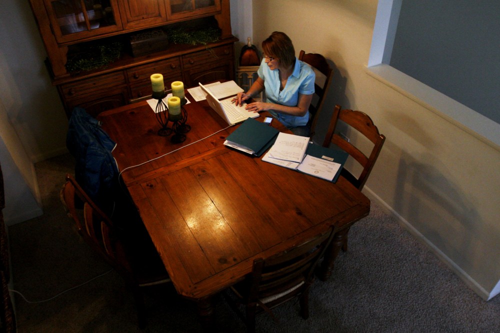 Debbie Jurcak, a mother of three, works on an application for state aid at her apartment in Aurora, Ill. Jurcak, 43, was among many Americans who lost unemployment benefits in late December.