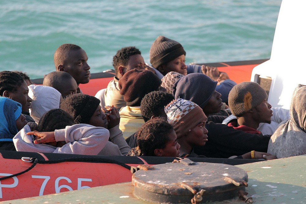 Migrants on a Coast Guard dinghy boat arrive at the Sicilian Porto Empedocle harbor, Italy, Monday, April 13, 2015. Italy's Coast Guard helped save 144 migrants Monday from a capsized boat in the waters off Libya. (Photo by Calogero Montanalampo/AP)