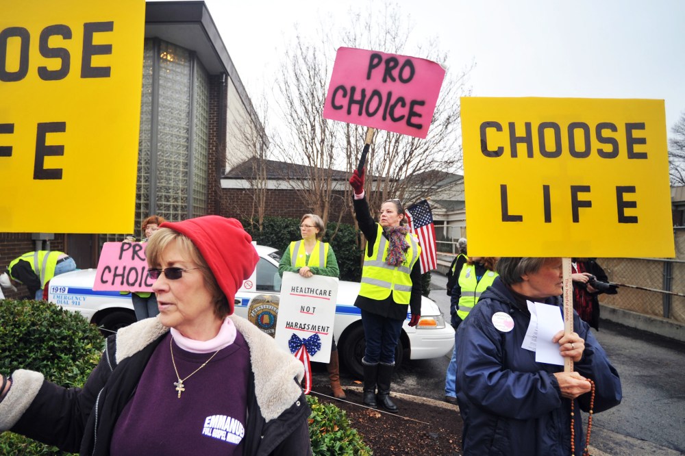 People supporting and opposing abortion demonstrate outside of the Alabama Women's Center for Reproductive Alternatives in Huntsville, Ala., Feb. 23, 2013.