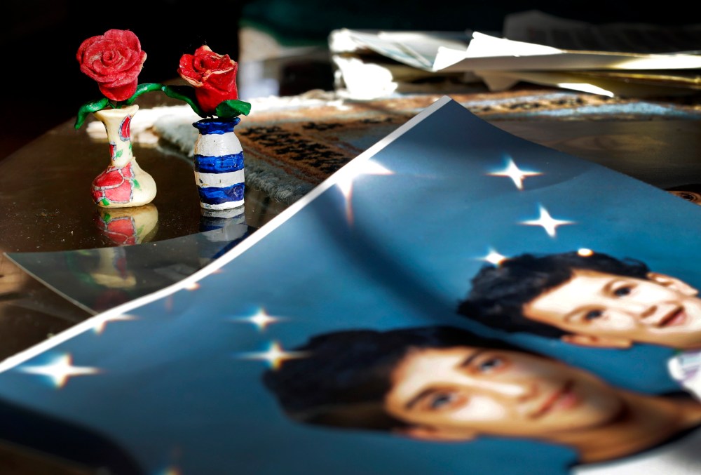 In this Dec. 10, 2014 photo, Prison artwork created by Adnan Syed sits near family photos in the home of his mother, Shamim Syed, in Baltimore, Md. (Photo by Patrick Semansky/AP)