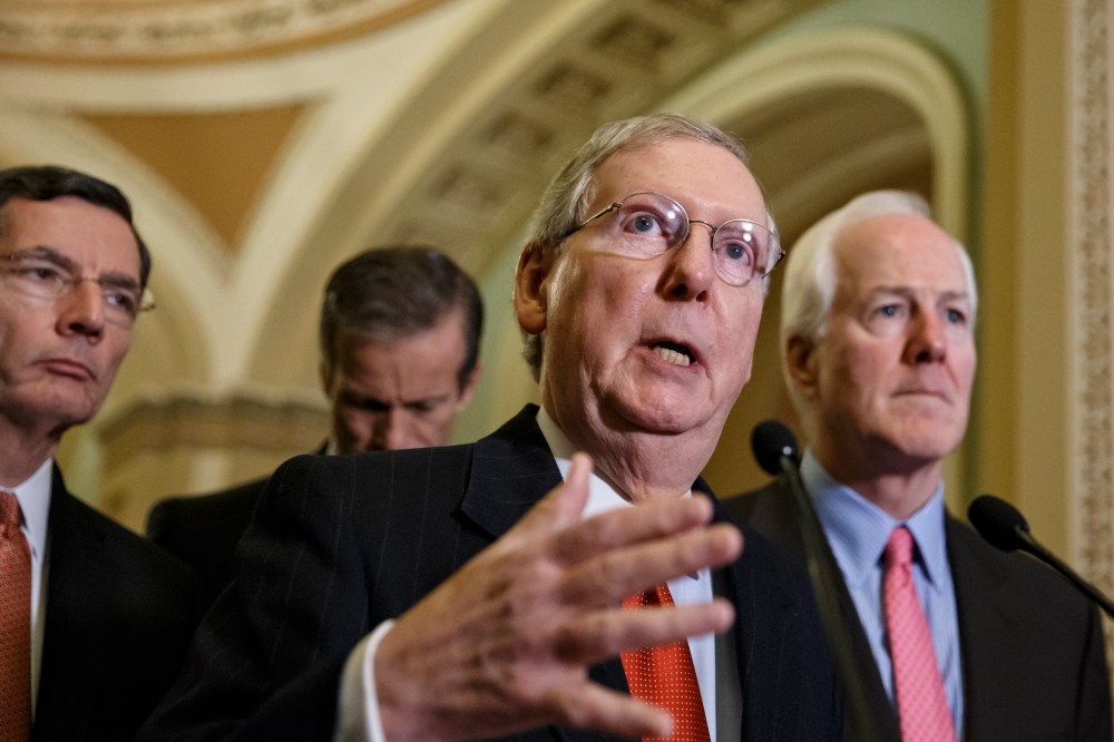 Senate Minority Leader Mitch McConnell speaks with reporters following a closed-door policy meeting at the Capitol in Washington on Dec. 2, 2014. (J. Scott Applewhite/AP)