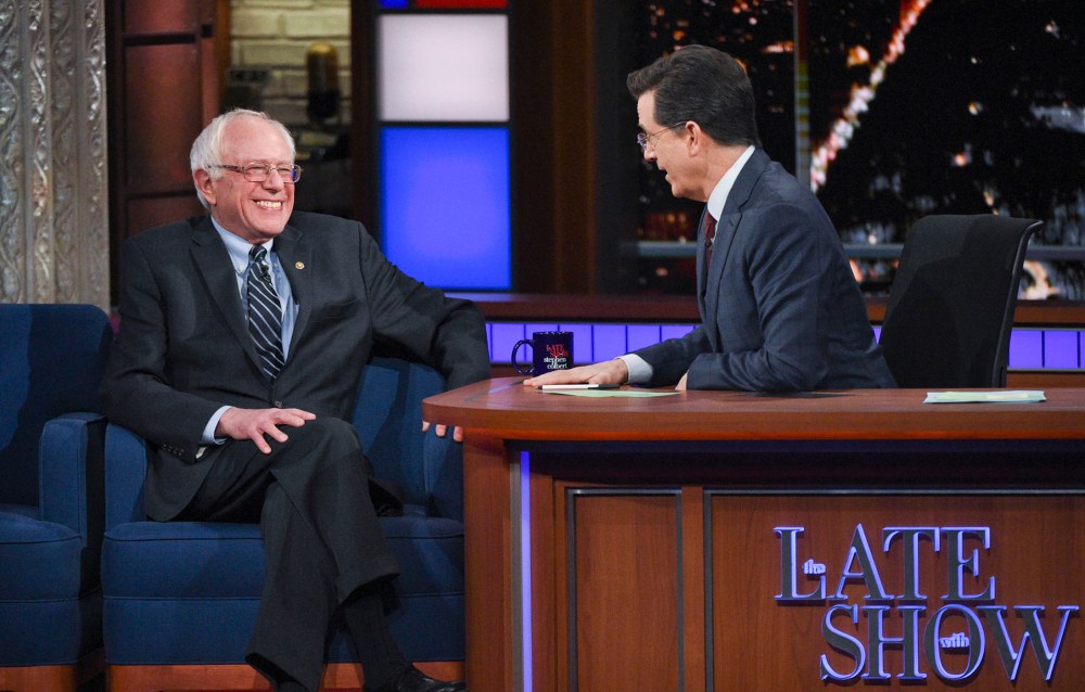 This image released by CBS shows Democratic presidential candidate Sen. Bernie Sanders, of Vermont, with host Stephen Colbert during a taping of "The Late Show with Stephen Colbert," Feb. 10, 2016, in New York. (Photo by Jeffrey R. Staab/CBS/AP)
