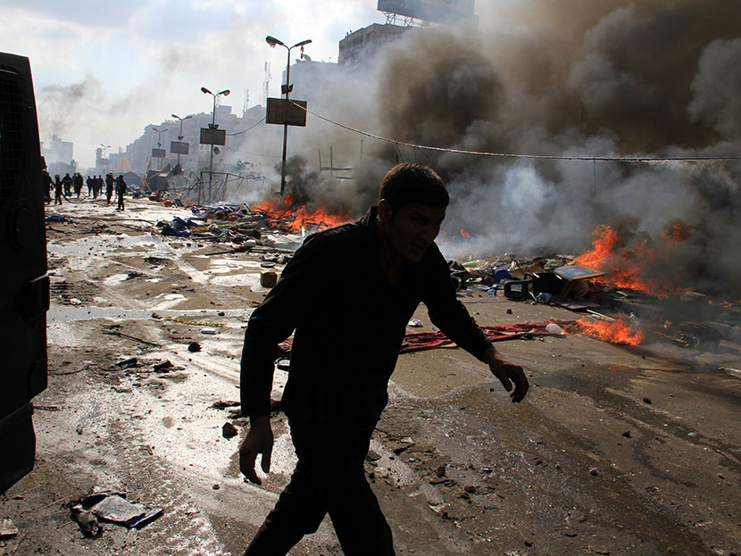 Egyptian security forces clear a sit-in by supporters of ousted Islamist President Mohammed Morsi in the eastern Nasr City district of Cairo, Egypt, Wednesday, Aug. 14, 2013. (Photo by Ahmed Gomaa/AP)