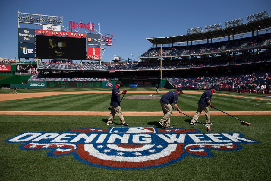 Washington Nationals groundskeepers prepare the field before an opening day baseball game between the New York Mets and Washington Nationals at Nationals Park on April 6, 2015, in Washington, D.C. (Evan Vucci/AP)