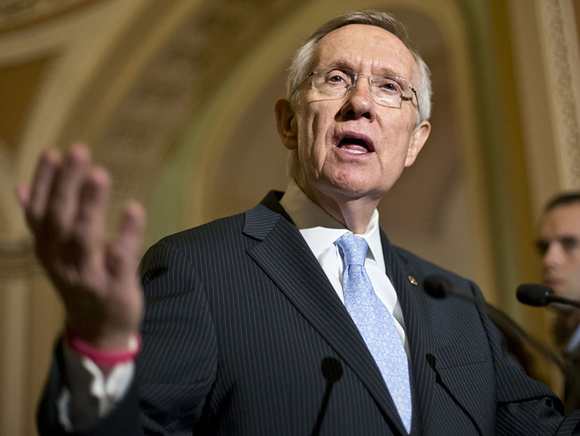 Senate Majority Leader Harry Reid of Nev. gestures as he speaks with reporters on Capitol in Washington, Tuesday, July 9, 2013 (Photo by J. Scott Applewhite/AP)