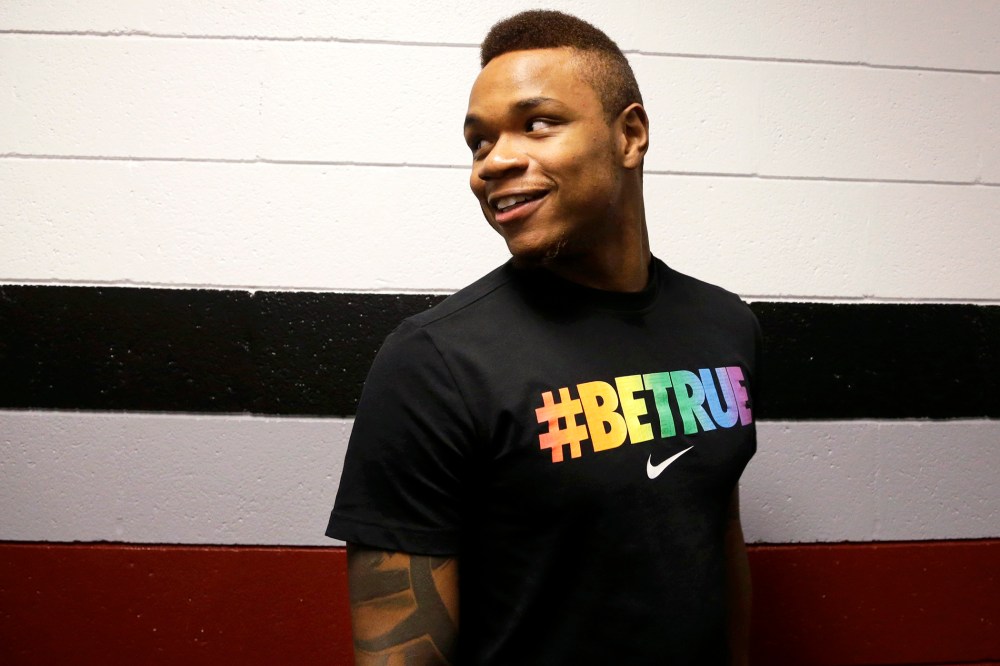 University of Massachusetts basketball guard Derrick Gordon, 22, enters a hallway before facing reporters on the school's campus, April 9, 2014.