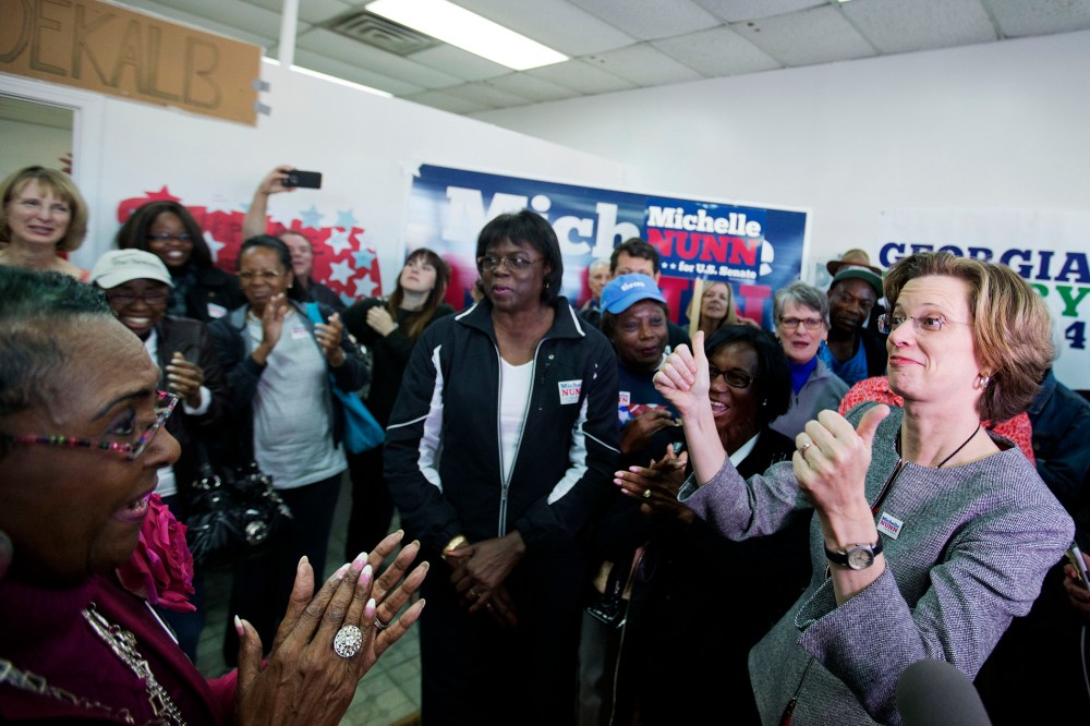Georgia U.S. Senate Democratic candidate Michelle Nunn, right, greets supporters at a campaign field office, Monday, Nov. 3, 2014, in Decatur, Ga. (Photo by David Goldman/AP)