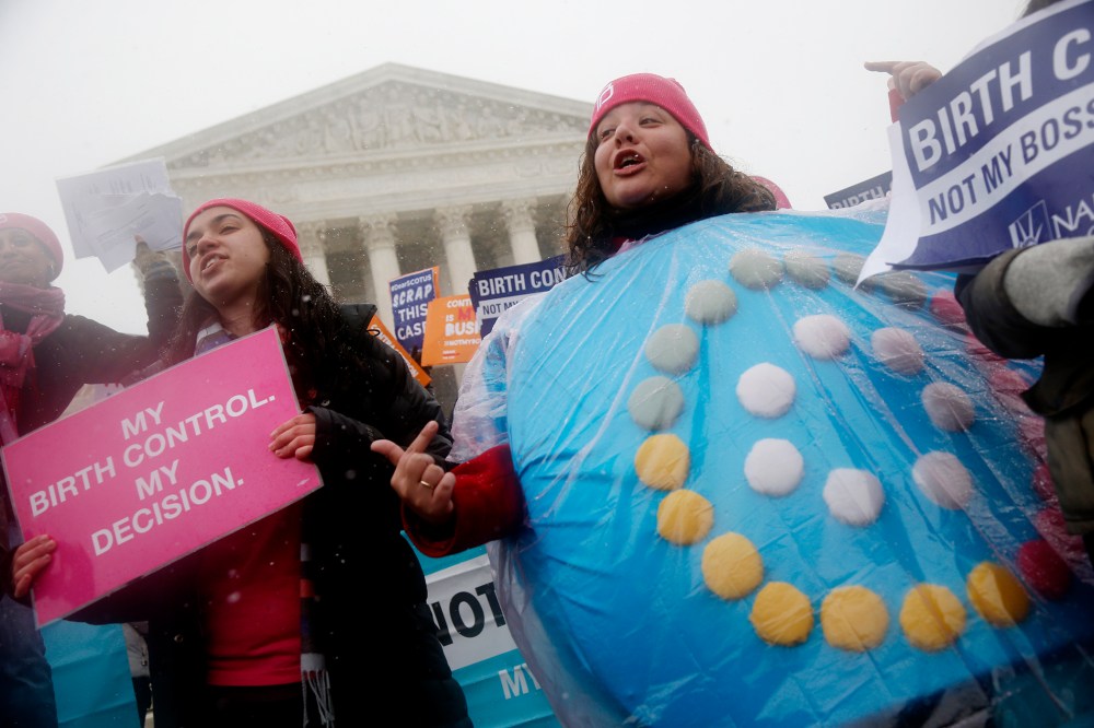 Women protest in front of the Supreme Court in Washington, March 25, 2014.