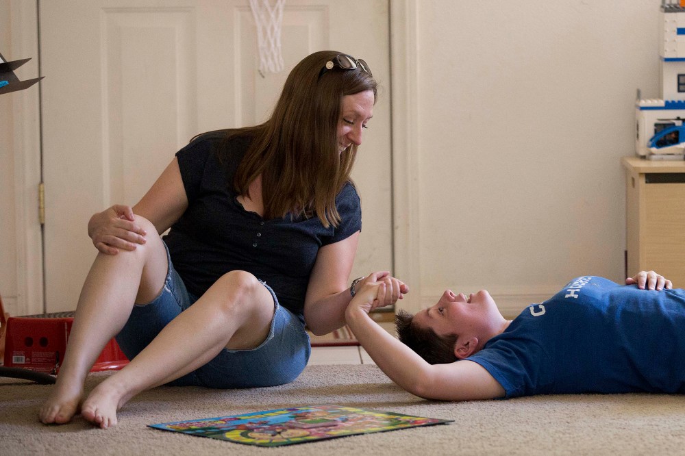 Megan Lanz, left, and her partner, Sara Geiger, take a break from playing with their 3-year-old daughter Jordan (not pictured) at their home, Sunday, April 29, 2012, in Las Vegas.
