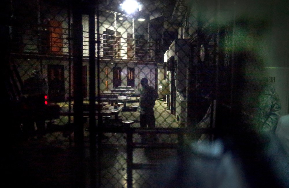 In this photo reviewed by the U.S. military, detainees behind a mirrored one-way window are pictured in Camp VI detention facility at Guantanamo Bay Naval Base, Cuba, Nov. 20, 2013. (Photo by Charles Dharapak/AP)