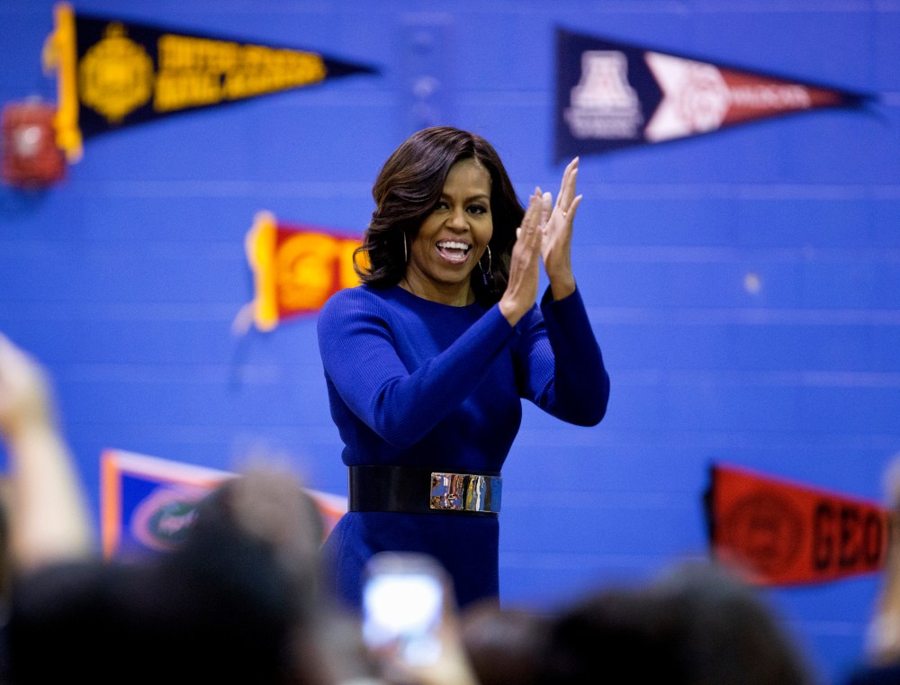 First lady Michelle Obama arrives to speak at Capital City Public Charter School in Washington, Dec. 5, 2014, during the second annual College Application March, part of her Reach Higher initiative. (Photo by Carolyn Kaster/AP)