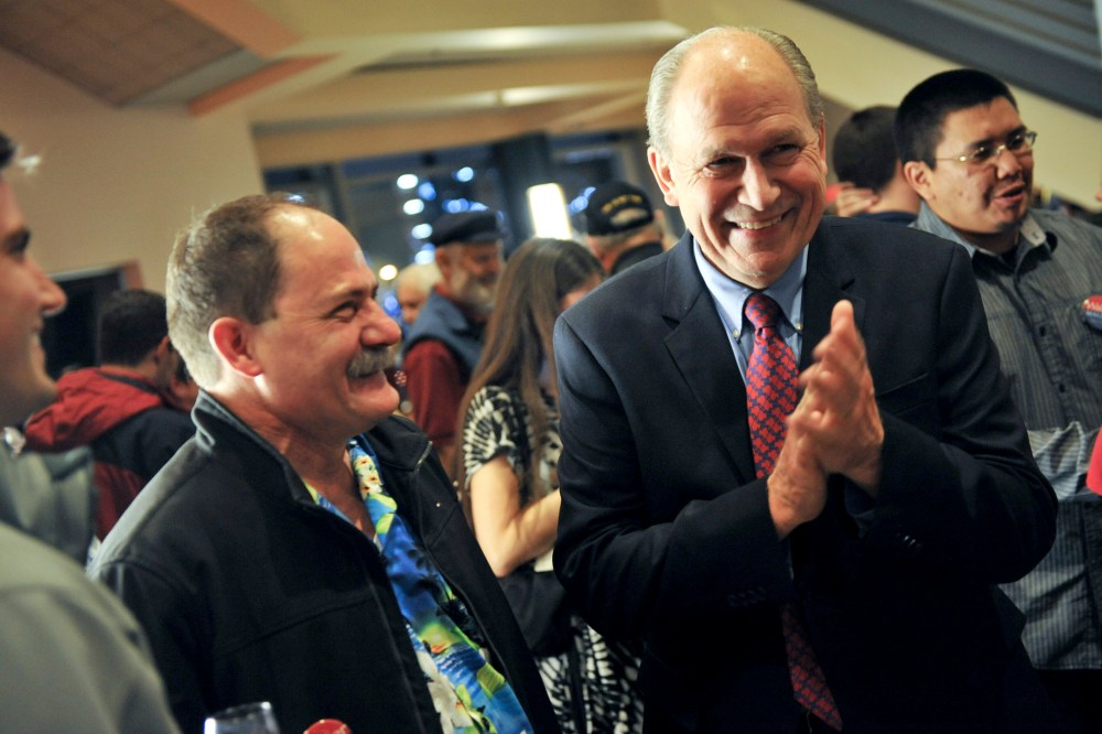 Alaska Independent gubernatorial candidate Bill Walker, right, laughs while awaiting election results, Nov. 4, 2014, in Anchorage, Alaska. (Photo by Michael Dinneen/AP)