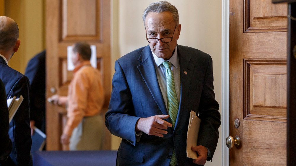 Sen. Chuck Schumer and members of the Democratic caucus file out of a strategy session at the Capitol in Washington on Nov. 18, 2014. (Photo by J. Scott Applewhite/AP)