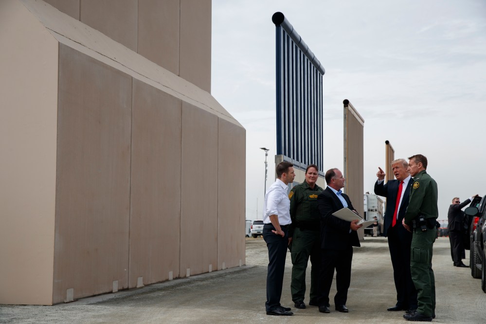 President Donald Trump reviews border wall prototypes, Tuesday, March 13, 2018, in San Diego.