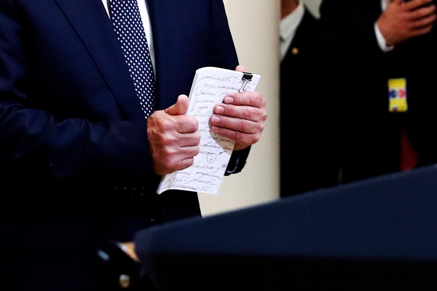 A cropped version of a photo of Russian President Vladimir Putin holding notes at a press conference after meeting with Donald Trump in the Presidential Palace in Helsinki, Finland, July 16, 2018.