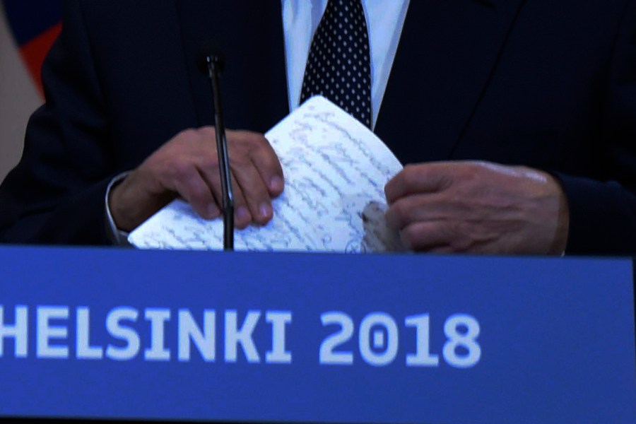 A cropped version of a photo of Russian President Vladimir Putin holding notes at a press conference after meeting with Donald Trump in the Presidential Palace in Helsinki, Finland, July 16, 2018.