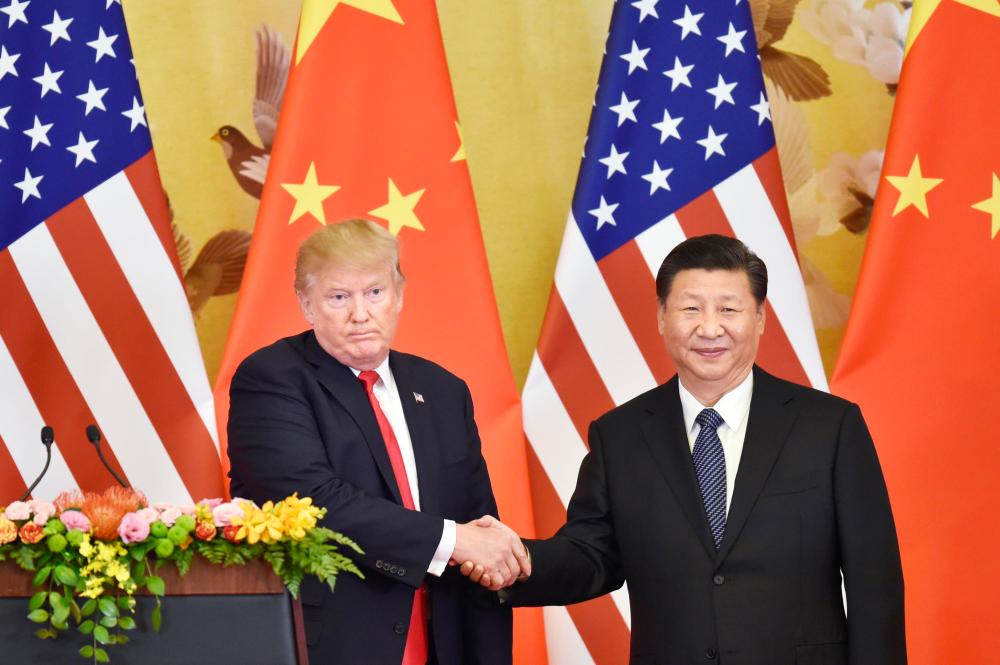 Photo shows U.S. President Donald Trump (L) and Chinese President Xi Jinping shaking hands during a joint press conference at the Great Hall of the People in Beijing in November 2017.