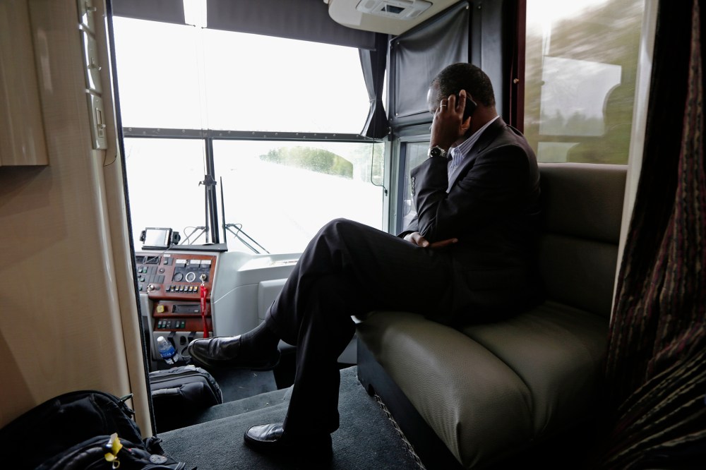 Republican presidential candidate, retired neurosurgeon Ben Carson answers a question during a phone interview as he travels on his bus tour near Lexington, N.C., Sept. 28, 2015. (Photo by Chuck Burton/AP)