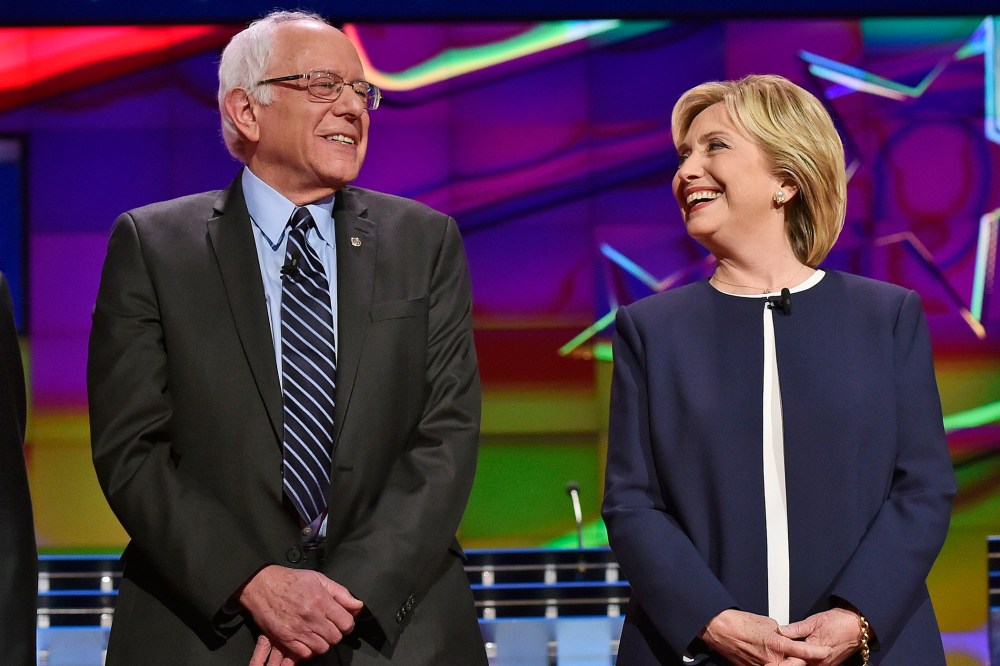 Democratic presidential candidates Sen. Bernie Sanders and Hillary Rodham Clinton talk before the CNN Democratic presidential debate on Oct. 13, 2015, in Las Vegas, Nev. (Photo by David Becker/AP)