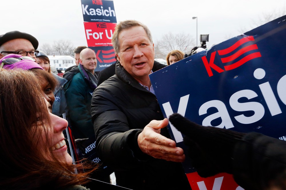 Republican presidential candidate, Ohio Gov. John Kasich greets supporters at a polling station at the high school, Feb. 9, 2016, in Manchester, N.H. (Photo by Jim Cole/AP)