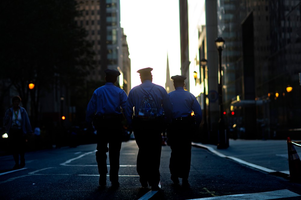Police walk along Arch Street, Sept. 27, 2015, in Philadelphia, Pa. (Photo by David Goldman/AP)