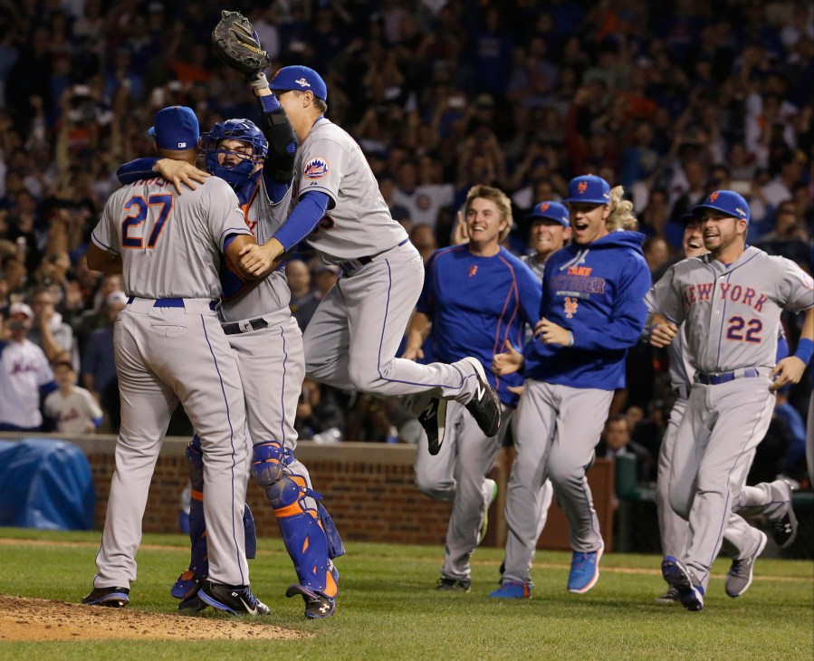 The New York Mets celebrate after Game 4 of the National League baseball championship series against the Chicago Cubs, Oct. 21, 2015, in Chicago, Ill. (Photo by Nam Y. Huh/AP)