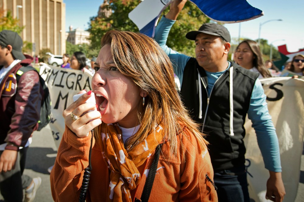 Jeanette Trejo chants as she marches during an immigration reform rally on Nov. 21, 2015, in Austin, Texas. (Photo by Jay Janner/Austin American-Statesman/AP)