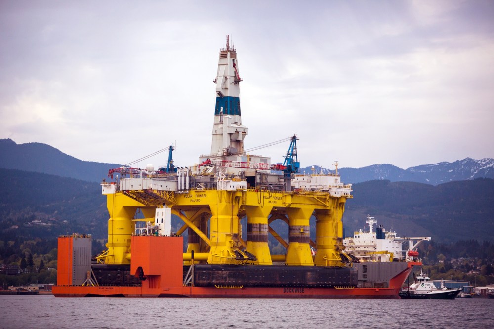 The Polar Pioneer oil drilling rig arrives aboard a transport ship, following a journey across the Pacific, in view of the Olympic Mountains in Port Angeles, Wash. on April 17, 2015. (Photo by Daniella Beccaria/seattlepi.com/File/AP)