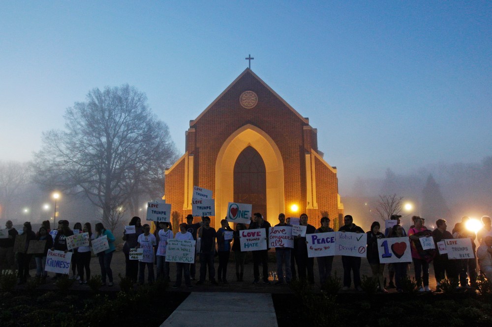 Protesters wait before dawn outside a church at Lenoir-Rhyne University before a rally for Republican presidential candidate Donald Trump in Hickory, N.C., March 14, 2016. (Photo by Chuck Burton/AP)