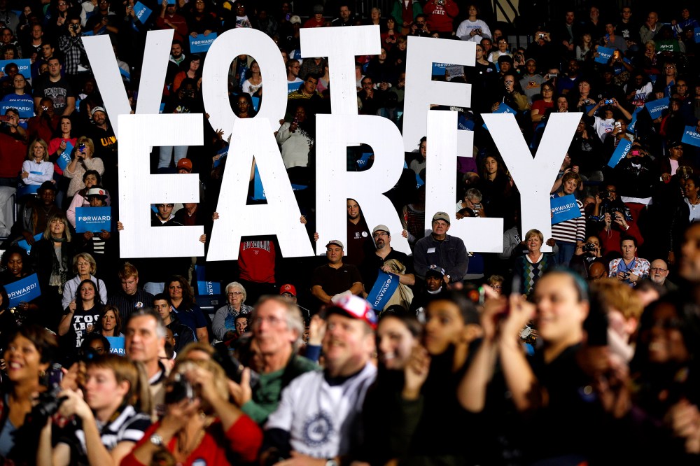 In this Oct. 29, 2012 file photo a "Vote Early" sign is held up by supporters at a rally for President Barack Obama in Youngstown, Ohio, referring to the "golden week" now in contention. (Photo by Matt Rourke/AP)