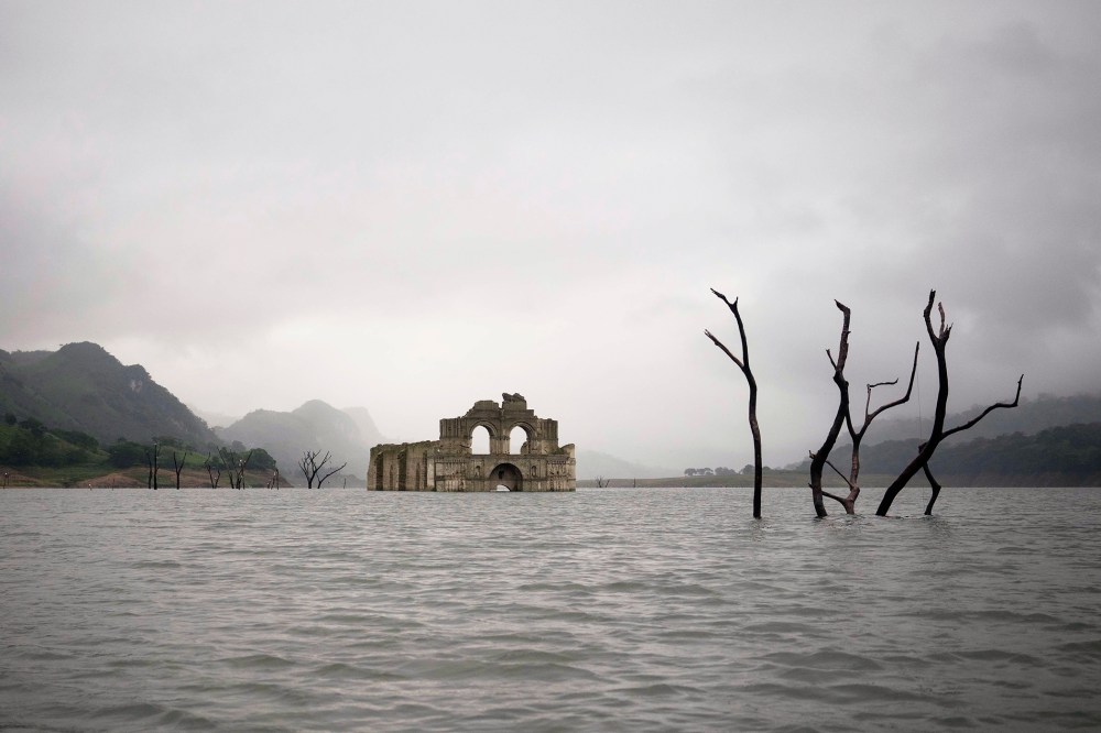 The remains of a mid-16th century church known as the Temple of Santiago, visible from the surface of the Grijalva River due to the lack of rain near the town of Nueva Quechula, in Chiapas state, Mexico, Oct. 16, 2015. (Photo by David von Blohn/AP)