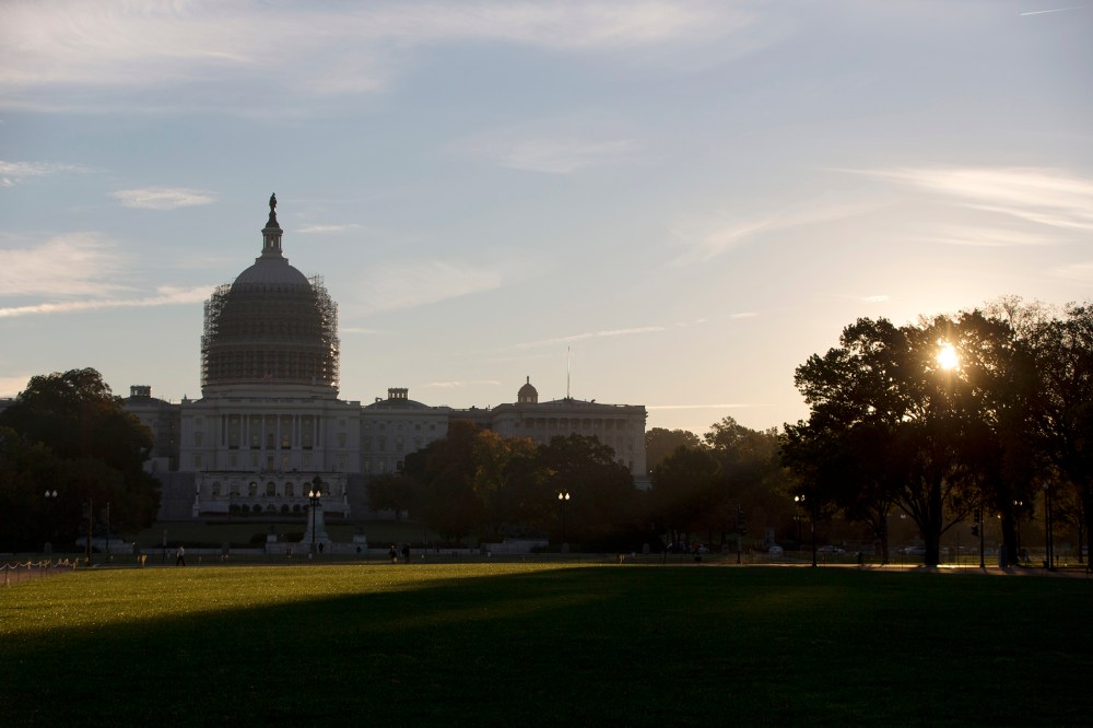 The sun rises behind the U.S. Capitol Building grounds in Washington, D.C., Oct. 20, 2014. (Photo by Carolyn Kaster/AP)